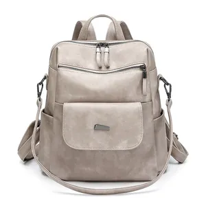 Detail of multi-functional PU leather backpack showing side pockets and metal hardware