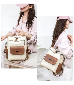 Detail of cream and brown patchwork backpack showing multi-pocket design and adjustable straps