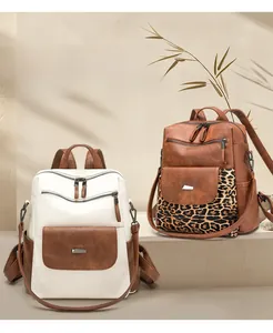 Detail view of stylish PU leather backpacks with leopard print and multi-pocket design
