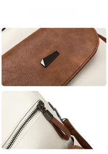 Detail view of lychee pattern leather backpack with color block design and metal buckle