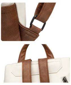 Detail of PU leather backpack straps and black metal hardware with white and brown stitching