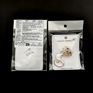 Detail view of cat enamel brooch packaging with front and back brand card