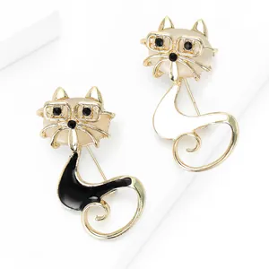 Cat brooch set with glasses design in black and white enamel on a white geometric stage