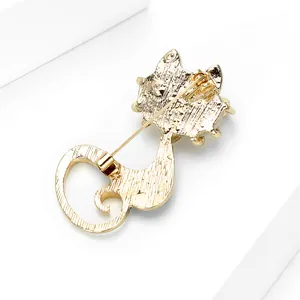 Golden cat brooch with back detail and safety pin closure on white display stand