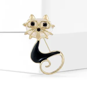 Macro detail of cat brooch with white opal stone head and golden frame glasses