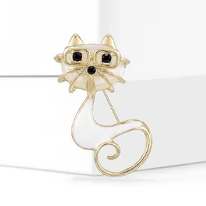 Macro detail of cat brooch with gold frame, white opal head and fine enamel finish