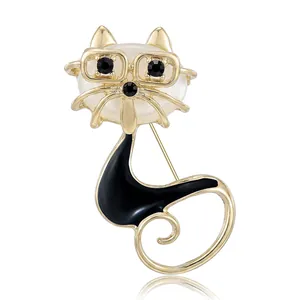 Elegant cat brooch with glasses and pearl head featuring black enamel and gold finish