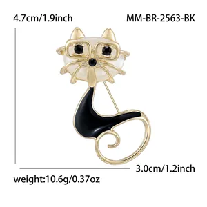 Cat brooch with black glasses and faux pearl head in gold finish, size 4.7cm x 3.0cm