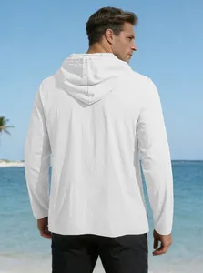 Rear view of white linen hooded shirt with drawstring on a sunny beach setting