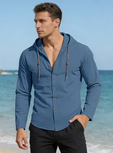 Detail of blue cotton linen hooded shirt featuring dark buttons and woven drawstrings