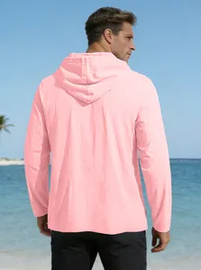 Men's light pink hooded cotton linen shirt shown in a breezy seaside vacation setting