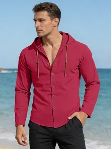 Detail of red hooded cotton shirt with drawstring and buttons on a sunny beach background