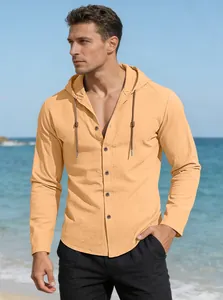 Close-up of light orange hooded cotton linen shirt with drawstring and buttons on beach
