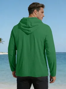 Back view of men's emerald green hooded cotton shirt on a sunny beach setting