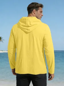 Macro detail of breathable cotton linen texture on yellow hooded shirt at beach