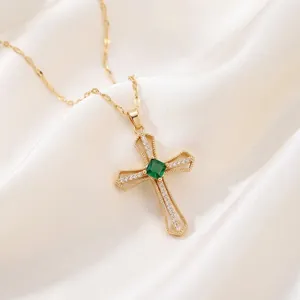 Golden cross necklace with green zircon gemstone and diamonds on white silk