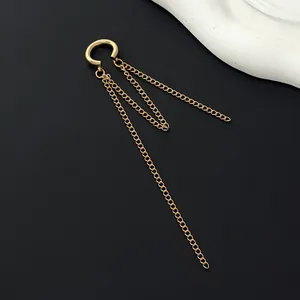 Detail showing the gold C-shaped ear cuff with three dangling metal tassel chains