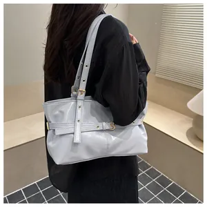 Détail du sac cabas en cuir ciré bleu clair avec œillets métalliques et boucles de mode