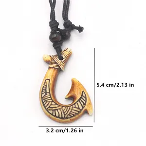Detail view of Maori fish hook pendant with size markings 5.4cm height and 3.2cm width