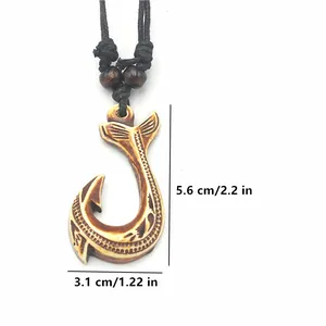 Detail showing Hei Matau fish hook pendant dimensions with tribal carvings and woven cord