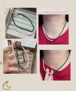 Detail of asymmetrical S925 silver necklace with white pearls and emerald green sandstone
