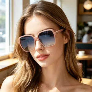 Close-up of pink oversized rectangular folding sunglasses with gradient lenses on a model