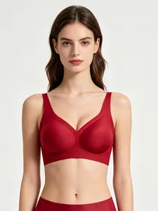 Front view of seamless red V-neck sports bra with wide ribbed support band and smooth fabric
