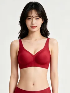 Detail of dark red seamless V-neck bra with jelly strip support and ribbed hem texture