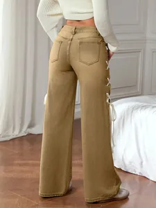 Detail showing side lace-up silk ribbon bow on khaki high waist wide leg jeans