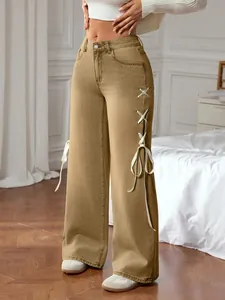Detail of khaki wide-leg jeans featuring side satin ribbon lace-up bow ties