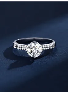Macro detail of a sparkling 1 carat round Moissanite ring with pavé silver band