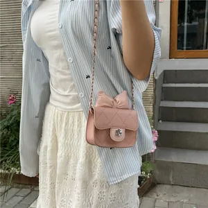 Pink quilted crossbody bag for girls with bow decoration and flower twist lock