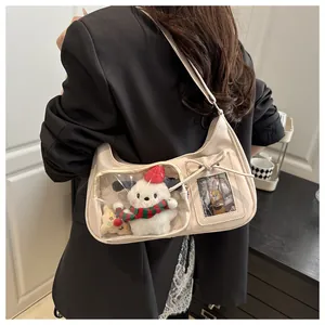 Detail view of a beige PU leather clear window display bag with plush dog inside