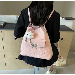 Pink pleated backpack with silver butterfly buckle and white cloud plush charm on model