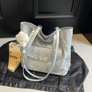 Silver metallic tote bag with crinkled texture, butterfly buckle and cloud charm