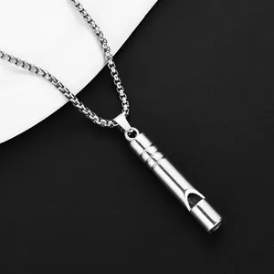 Macro view of silver whistle pendant with venetian box chain on black and white background