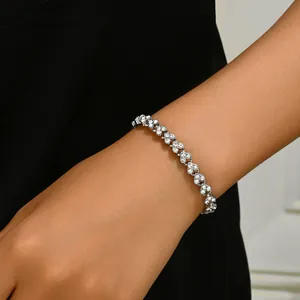 Close-up of heart-shaped linked bracelet with crystal zircons on female wrist
