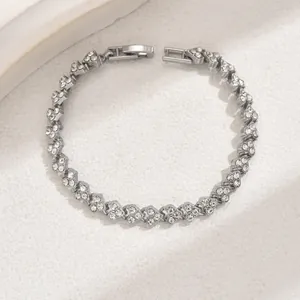 Detailed view of silver heart-shaped chain bracelet with sparkling pavé crystals