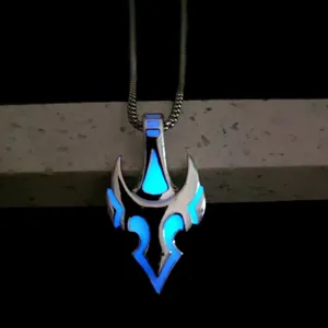 Luminous bull skull pendant with blue glow effect on silver snake chain detail