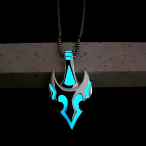 Luminous bull head helmet pendant showing bright turquoise glow in the dark background