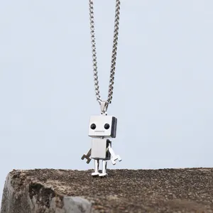 Robot pendant necklace in silver stainless steel on rock base with blue background