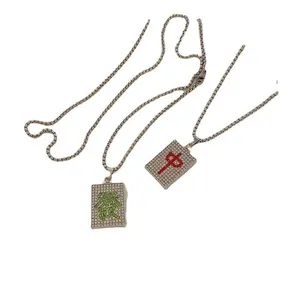 Close-up of hip hop mahjong pendants featuring red and green iced-out crystal stones