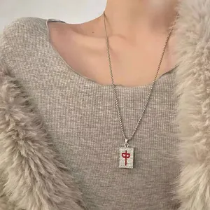 Detailed close-up of Mahjong Hong Zhong pendant necklace with full diamond inlay on model