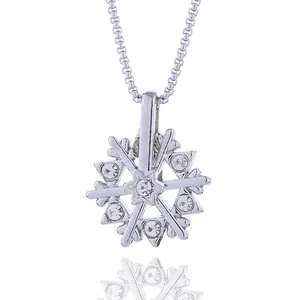 Macro view of rotating snowflake pendant with sparkling crystals on a silver box chain
