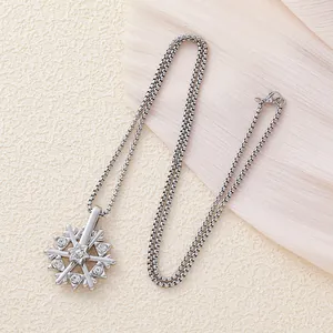 Rotating snowflake pendant necklace with sparkling crystals and silver box chain