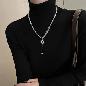 Macro detail of luxury snowflake Y-shaped pendant necklace with elegant metal tassels