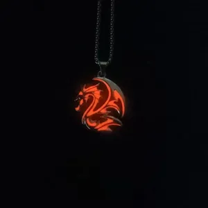 Detailed view of dragon totem pendant with glowing red luminous effect on bead chain
