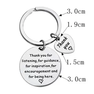 Detailed macro of polished steel keychain with engraved quote and small heart charm