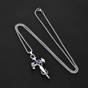 Macro shot of retro silver sword pendant with snake wrap and blue gemstone detail
