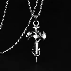 Macro shot of punk style dagger pendant with snake and zircon on silver box chain